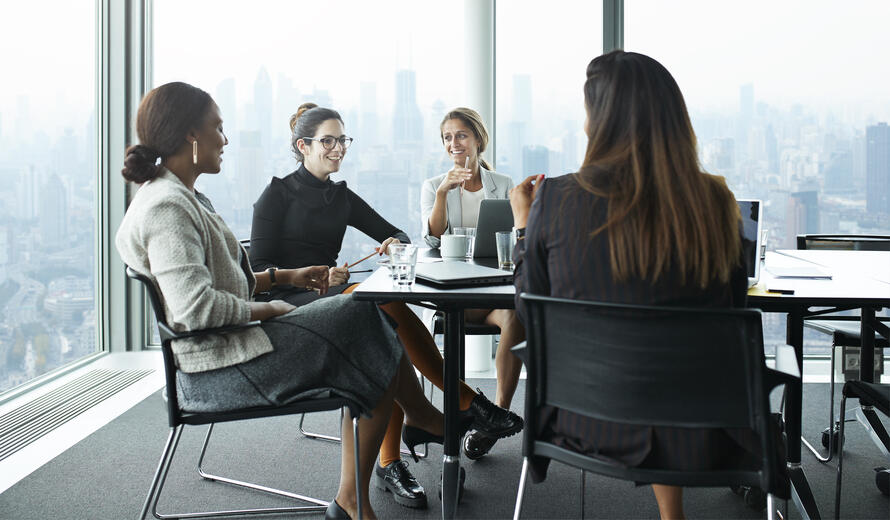 Business people in large modern meeting room