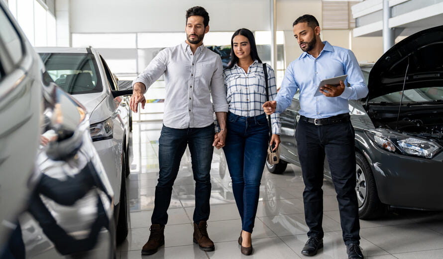 people looking at cars