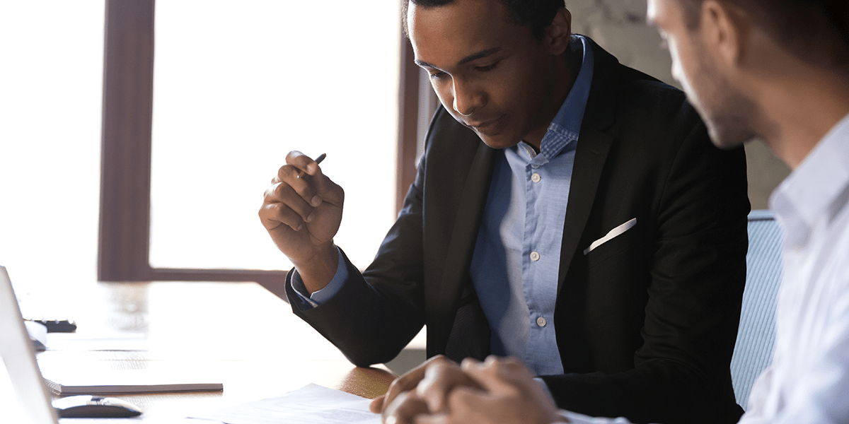 men signing papers